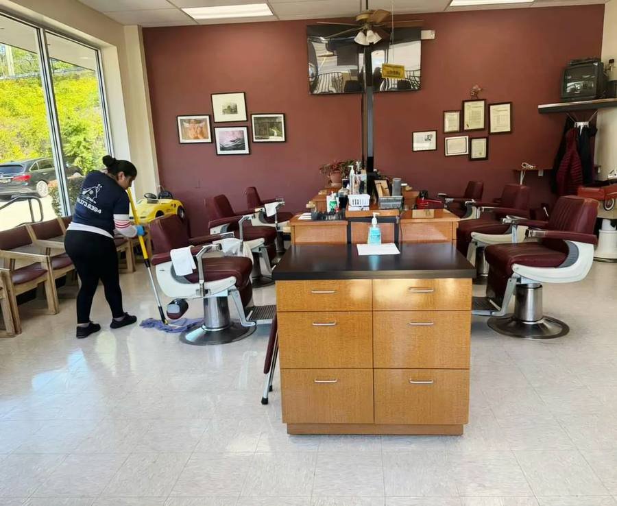 Mopping the floor of a barbershop